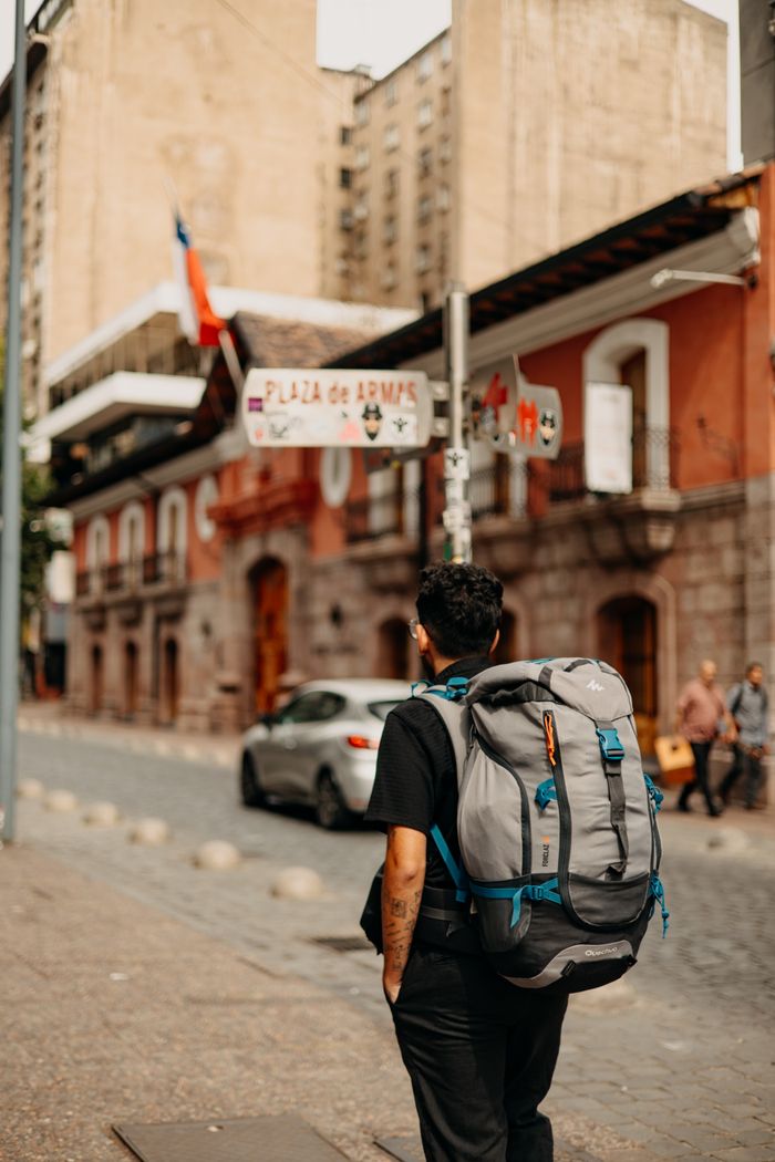 team-03 A backpacker exploring the streets near Plaza de Armas, Santiago, Chile.
